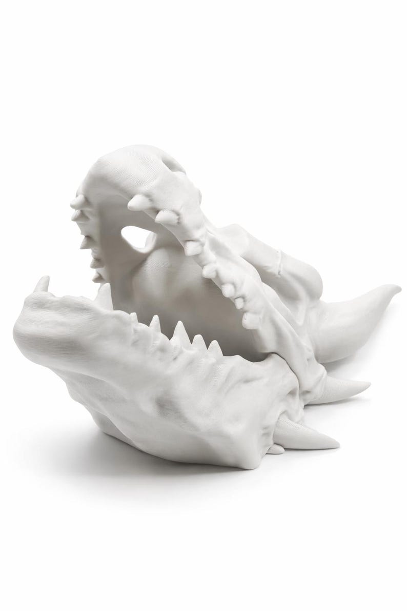 Angled side view of the dragon skull planter highlighting layered bone texture and open jaw.