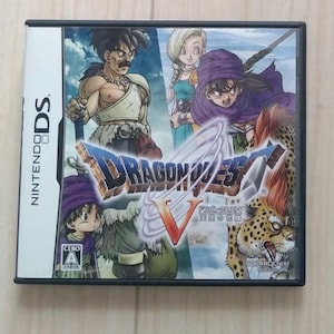 May include: Nintendo DS game case for Dragon Quest V. The cover art features several characters in a fantasy setting, with the game's title prominently displayed. The case is black with the Nintendo DS logo on the side.