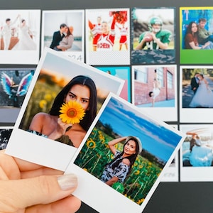 May include: A hand holds two instant photos featuring a woman in a sunflower field. Other photos on a black surface show various scenes, including a wedding, a cheerleader, and a football player. The photos have white borders.