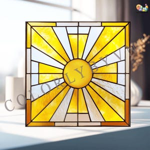 May include: Square stained glass panel with a sunburst design. The panel has a yellow centre and radiating yellow and white rays, framed in black. The text "COLORLY" is in the centre. Decorative home decor.