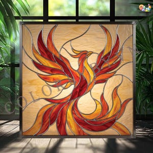 May include: Stained glass panel featuring a phoenix design. The artwork showcases a bird with outstretched wings in shades of red, orange, and yellow, set against a cream-colored background. The panel is framed in a dark metal.