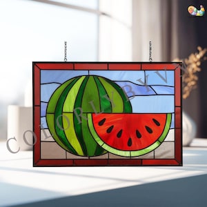 May include: Stained glass panel featuring a watermelon design. The artwork depicts a whole watermelon and a slice, with vibrant red, green, and black colors. The panel is framed in red and hangs by chains.