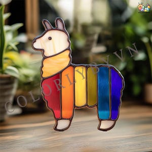 May include: A stained glass llama figurine with a rainbow design. The llama has a white head, a yellow neck, and a body with red, orange, yellow, green, blue, and purple panels. The figurine has a dark metal frame and is displayed on a wooden surface.