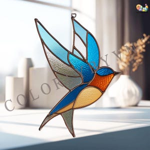 May include: Stained glass bird suncatcher in a vibrant design. The bird features shades of blue, orange, and yellow, with textured glass wings and a brown metal frame. A decorative piece for windows or walls.