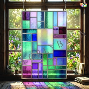 May include: A rectangular stained glass panel with a geometric design. The panel features an array of rectangular and square shapes in shades of purple, blue, green, and iridescent colors. The panel is framed in silver and hangs in front of a window.