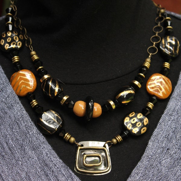 Kazuri with Gold - Necklace of Enameled Brass Shield, Kazuri, Jet and Brass Beads