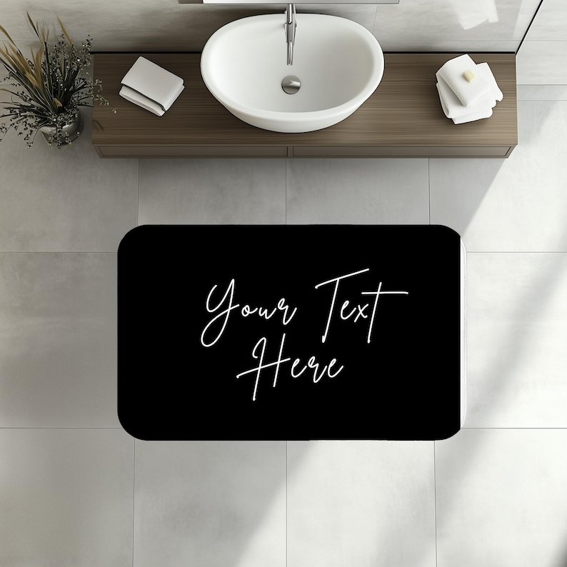 a bathroom with a sink and a black rug