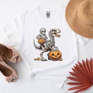Mummy Skeleton Riding Dinosaur T Rex Pumpkin Moon T-Shirt, Spooky Season Dino Shirt, Cute Halloween Party Top, Pumpkin Gift