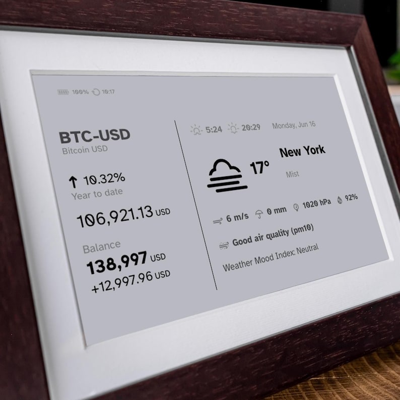 Stock, crypto, forex, ETF & precious metals e-ink live price ticker Brisa Frame rests on a table, encased in a handcrafted wooden frame with soft. The e-ink display shows MSCI ACWI live price (including wallet value), EURUSD currency exchange rate, AAPL stocks price & weather. Designed for slow living and mindful interiors, Brisa blends technology with calm aesthetics, delivering daily information in a serene, non-intrusive way.