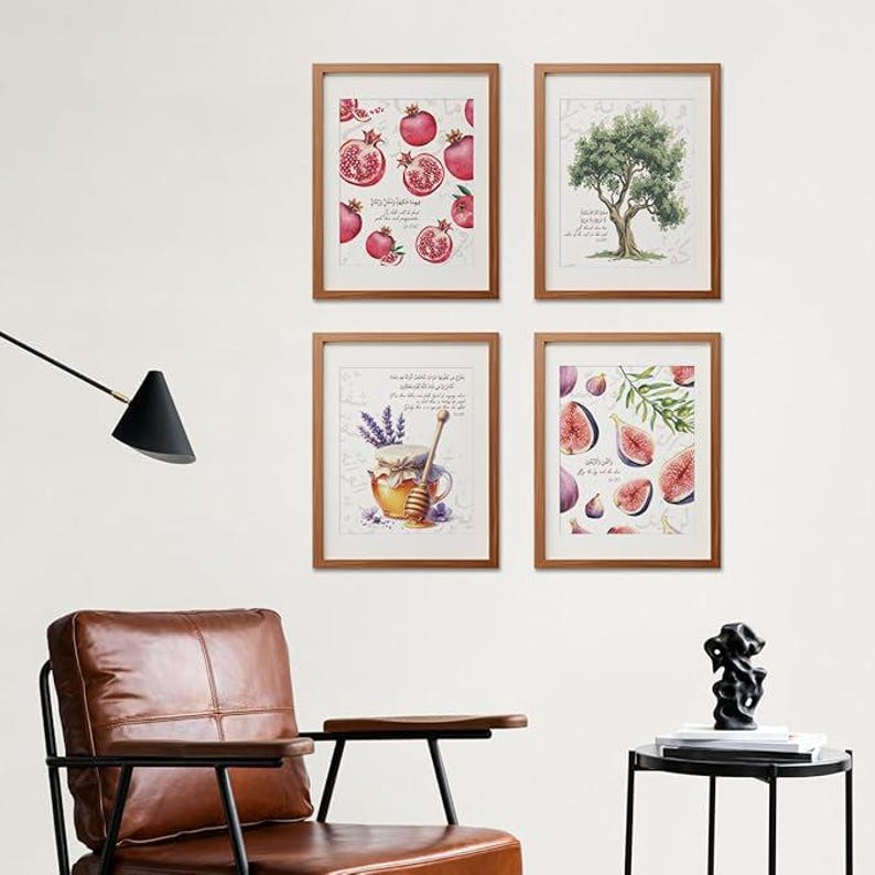 May include: Four framed art prints with wooden frames. The prints feature watercolor illustrations of pomegranates, an olive tree, honey and lavender, and figs. The art has a neutral color palette with pops of red, purple, and green.