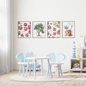 May include: Four framed art prints featuring botanical illustrations. The prints depict pomegranates, an olive tree, figs, and a honey pot with lavender. The prints are displayed above a small white table and light blue chairs.