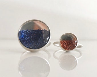 Handmade adjustable silver ring with acrylic cabochon and filled with metallic micro beads