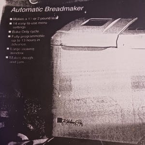 May include: A white bread maker with a large viewing window. The bread maker is advertised as being able to make a 1 1/2 or 2 pound loaf of bread. It has 14 easy-to-use menu settings, a bake only cycle, and is fully programmable up to 13 hours in advance. It also makes dough and jam.