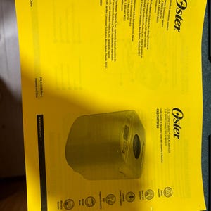 May include: A bright yellow user guide and recipe manual for an Oster 2lb Expressbake breadmaker, model CKSTBRTW20. The document features the Oster logo, contact information for customer service, and icons for safety, usage, cleaning, and warranty.