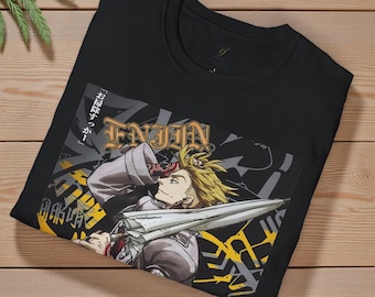 May include: Black t-shirt featuring a graphic of an anime character with blonde hair holding a sword. The graphic includes the word "ENJIN" in gold lettering and Japanese text. The shirt is folded on a wooden surface.