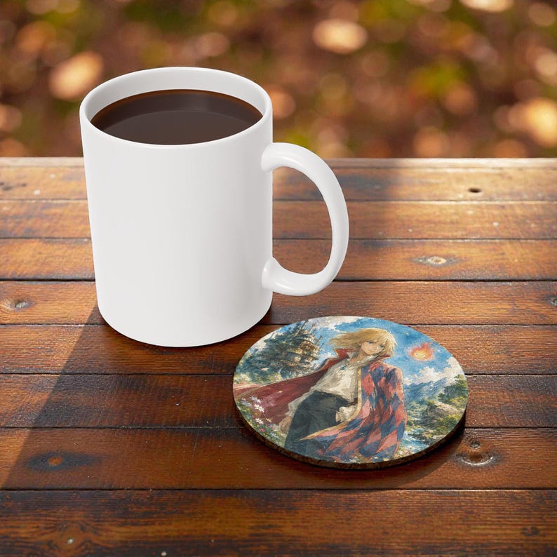 May include: A white ceramic coffee mug filled with dark liquid sits on a wooden surface next to a round coaster. The coaster features a colorful illustration of a person in a red and blue cloak.