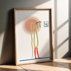 May include: A framed art print featuring a stylized illustration of a yellow and black snake with red legs. The snake hangs in front of a pink circle, with blue and green geometric shapes. The artwork is in a wooden frame.