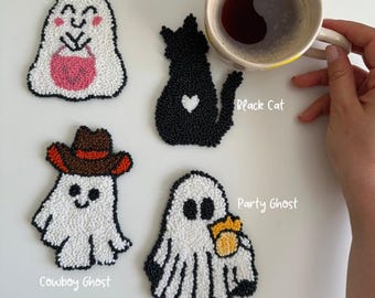 May include: Four handmade Halloween-themed coasters. The coasters include a white ghost with a pink candy bag, a black cat with a white heart, a white ghost with a cowboy hat, and a white ghost with a yellow bow. The text on the image says "Candy Ghost", "Black Cat", "Cowboy Ghost", and "Party Ghost".