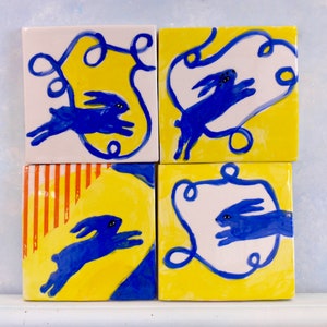 Blue bunny ceramic tile, handmade with frolicking blue rabbits. Fun, whimsical rabbit decor. Gift for nature lovers, baby,showers,birthday.