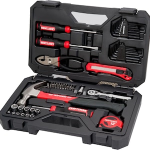May include: A black Craftsman tool set with a variety of tools, including screwdrivers, pliers, a hammer, and a tape measure. The tools have red and black accents and are neatly organized in a black case. The tape measure reads 12.