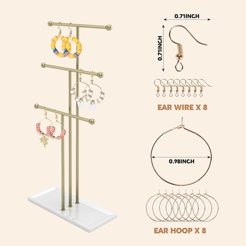 May include: A gold-coloured earring display stand with three tiers, holding various earrings. The stand has a white base. The image also shows ear wires (1.8 cm) and ear hoops (2.5 cm).