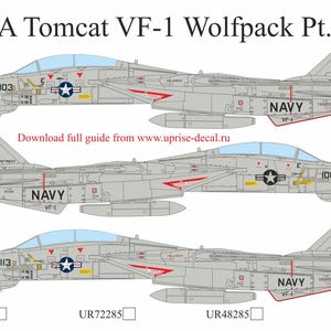 May include: Three side profiles of F-14A Tomcat fighter jets, in shades of gray, with red and blue accents. Each jet displays the word "NAVY" and a unique number. The image includes the text "F-14A Tomcat VF-1 Wolfpack Pt.I" and a website address.