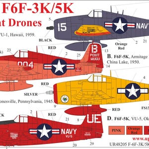 May include: A sheet of decals for 1/48 scale F6F-3K/5K Hellcat Drones. The sheet features detailed illustrations of the aircraft in various color schemes, including red, yellow, and navy blue, with markings and text.