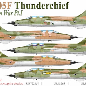 May include: An illustration of several F-105F Thunderchief fighter jets in a camouflage pattern. The image includes the text "F-105F Thunderchief Vietnam War Pt.I" and various markings on the aircraft, such as "RK 317", "JE 424", "JE 329", and "RU 424".