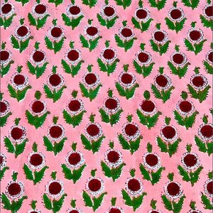 May include: A repeating floral pattern on a pink background. The design features dark red circular centers surrounded by white dots, green leaves, and stems. This textile design is suitable for fabric, wallpaper, or other decorative applications.