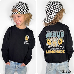 Personalized Jesus Lemonade Shirt with happy lemon graphics and the quote “Life Gave Me Some Lemons, But My Jesus He Be Makin’ Lemonade” — cute faith based kids sweatshirt and Christian shirt.
