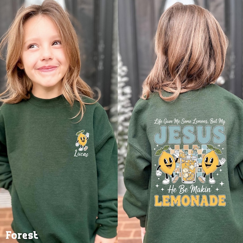 Personalized Jesus Lemonade Shirt with happy lemon graphics and the quote “Life Gave Me Some Lemons, But My Jesus He Be Makin’ Lemonade” — cute faith based kids sweatshirt and Christian shirt.