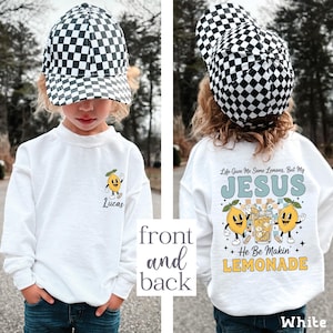 Personalized Jesus Lemonade Shirt with happy lemon graphics and the quote “Life Gave Me Some Lemons, But My Jesus He Be Makin’ Lemonade” — cute faith based kids sweatshirt and Christian shirt.
