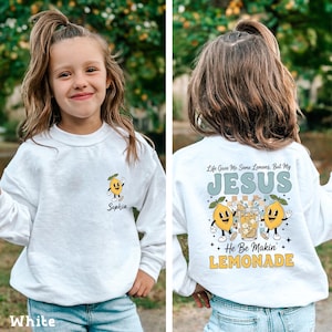 Personalized Jesus Lemonade Shirt with happy lemon graphics and the quote “Life Gave Me Some Lemons, But My Jesus He Be Makin’ Lemonade” — cute faith based kids sweatshirt and Christian shirt.