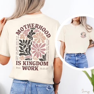 a woman wearing a white t-shirt with a floral design and text printed on it.
