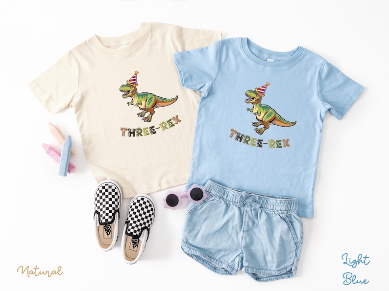 Dinosaur-themed family birthday shirts including a Three Rex or Four Rex kids tee with name and age on back, plus matching Mama Saurus, Dada Saurus, and sibling designs — ideal for dinosaur birthday parties.