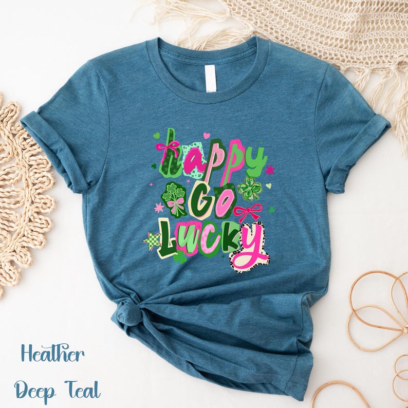 A blue t-shirt with a colorful graphic design that says "Happy Go Lucky" in a playful font.