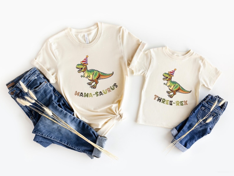Dinosaur-themed family birthday shirts including a Three Rex or Four Rex kids tee with name and age on back, plus matching Mama Saurus, Dada Saurus, and sibling designs — ideal for dinosaur birthday parties.