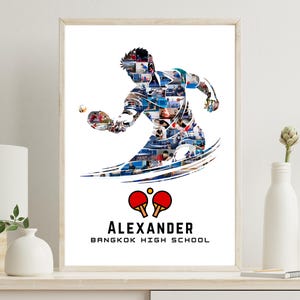 May include: A framed print featuring a silhouette of a table tennis player in action, composed of smaller images. Below the figure are two red ping pong paddles and the name "ALEXANDER" and "BANGKOK HIGH SCHOOL". The print is in a wooden frame.