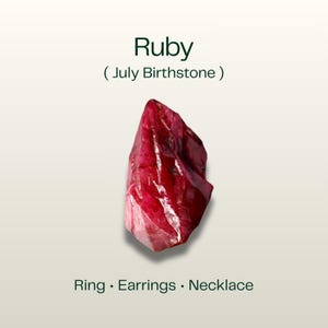May include: A rough-cut ruby gemstone, the July birthstone, in deep red and pink hues. The image includes the text "Ruby (July Birthstone)" and "Ring • Earrings • Necklace".