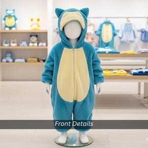 May include: A blue and cream-colored fleece jumpsuit with a hood, zipper, and character design. The costume is displayed on a mannequin. The text "Front Details" is at the bottom of the image.