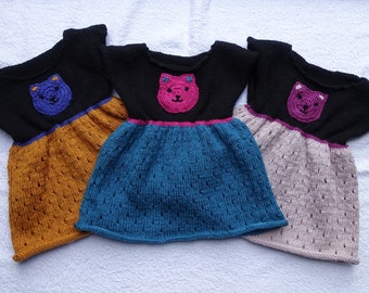 Baby girls sweater dress/tunic with elasticated waist. Hand knitted in three colour choices with cute cat motif. Age 12-18m, chest 20/21 in.