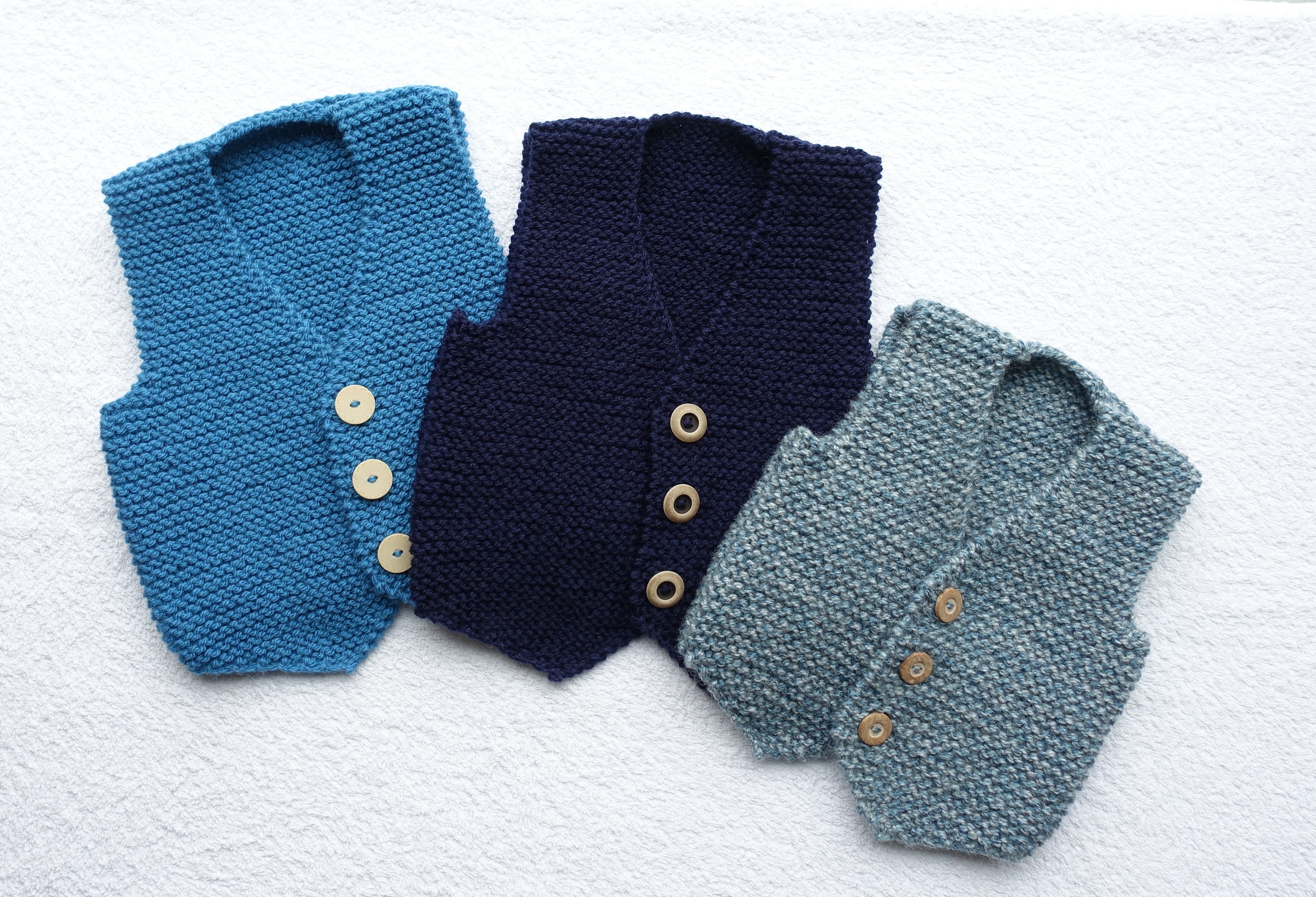 Baby boys vest/waistcoat/tank top/slip over hand knitted in three shades of blue yarn. Approx ages 12-18 months and 2-3 yrs
