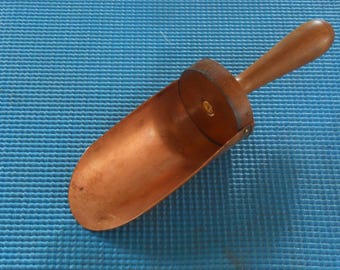 Hand crafted copper and wooden ladle for kitchen use. I use mine as an ice scoop in our ice maker.