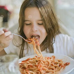 May include: A young person eating spaghetti with tomato sauce from a white plate. The person is holding a fork with spaghetti strands in their mouth. The pasta is covered in red sauce.