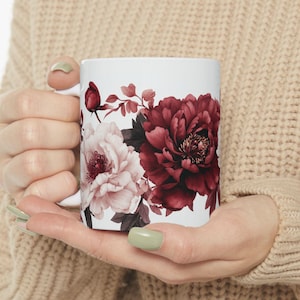 white coffee mug with a flower design on it
