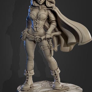 May include: A light gray unpainted resin miniature figure of a hooded elf character wearing a corset, pants, and boots, standing on a circular stone-textured base. The figure features a flowing cape, a belt with a pouch, and a sheathed dagger at the hip.