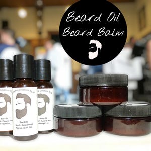 Puede incluir: Tres frascos de vidrio ámbar con tapas negras y etiquetas blancas, y tres tarros de vidrio ámbar con tapas negras. Las etiquetas presentan un icono de barba y texto que incluye Beard Oil, Phoenix Fire, Sandalwood y Lumber Jack. Un gráfico circular negro muestra el texto Beard Oil Beard Balm con un icono de barba.
