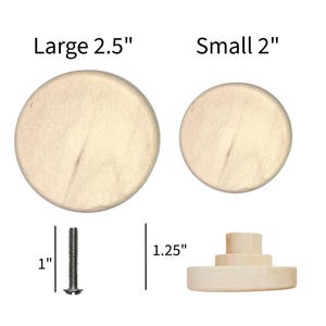 May include: Two round, light-colored wooden knobs with smooth surfaces. The large knob is 2.5 inches in diameter, and the small knob is 2 inches. A metal screw measuring 1 inch is shown next to a side view of a knob with a 1.25-inch height.