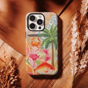May include: A phone case featuring a vibrant watercolor design with tropical elements. The design includes a crab, goldfish, palm tree, cocktail, and sliced citrus fruits. The case has a black border and a glossy finish, perfect for protecting your phone.