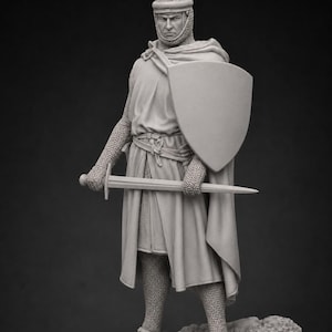 May include: A monochromatic gray figurine of a medieval knight standing on a rocky base. The knight wears a chainmail coif, a long tunic, and chainmail leggings. A cloak is draped over the shoulders, and the knight holds a sword and a shield.